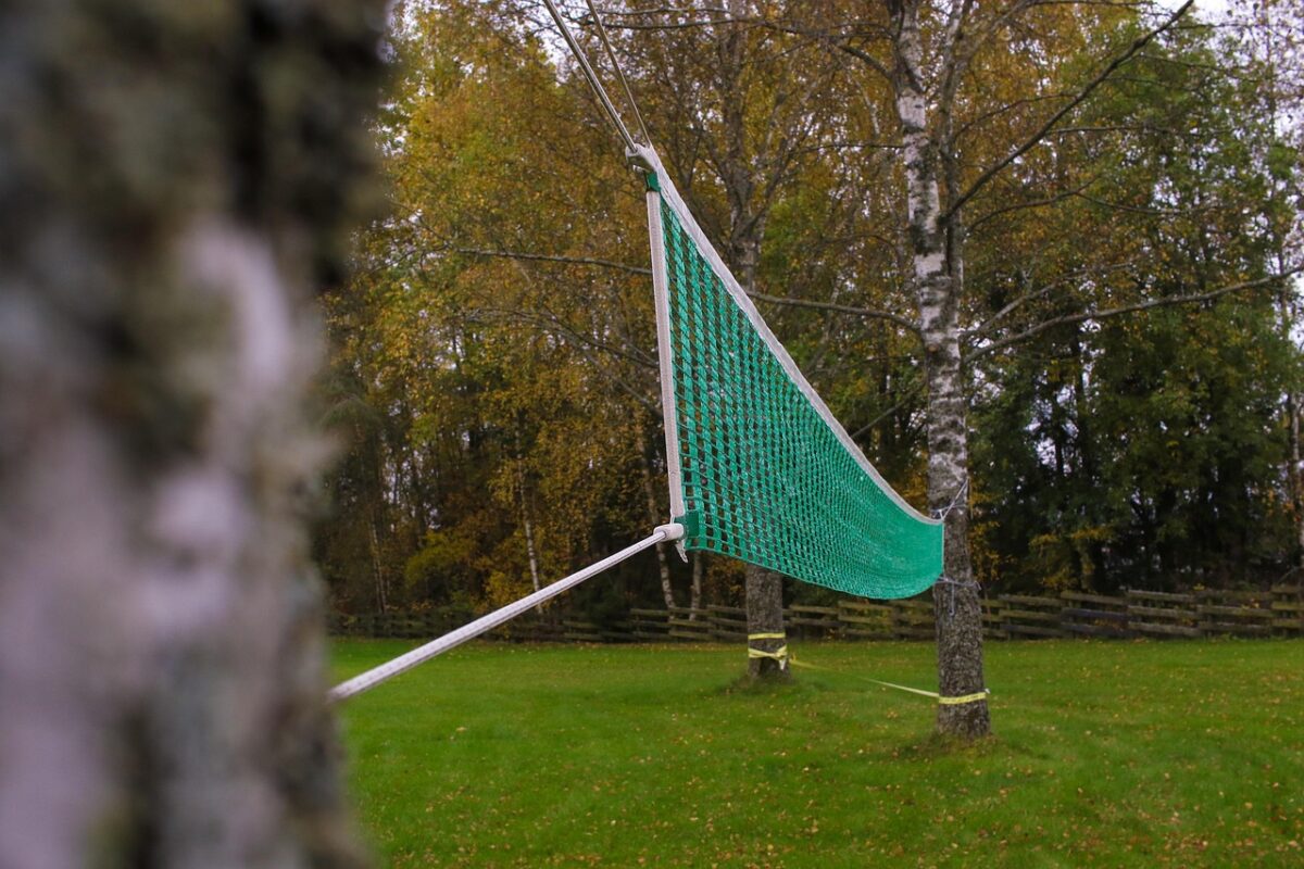 A volleyball rebound net in a backyard